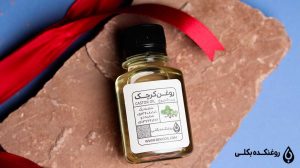 روغن کرچک در بطری بر روی سنگ